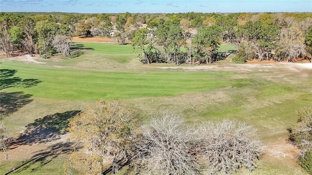 birds eye view of property featuring golf course view and a forest view