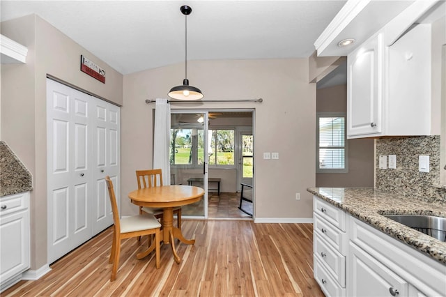 dining room featuring baseboards and light wood finished floors