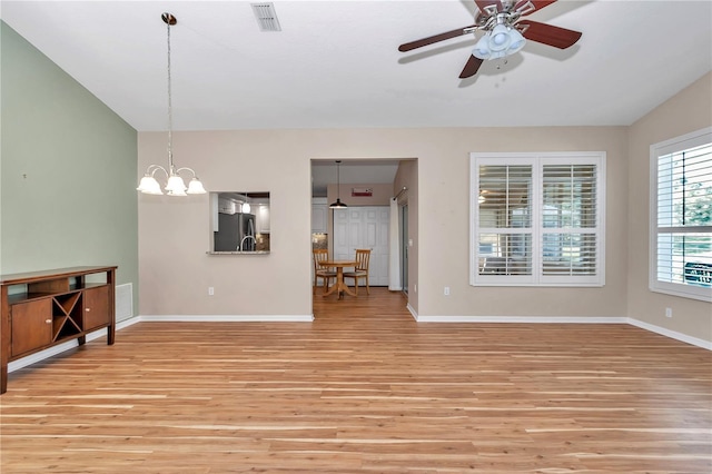 living area with visible vents, light wood-type flooring, and baseboards