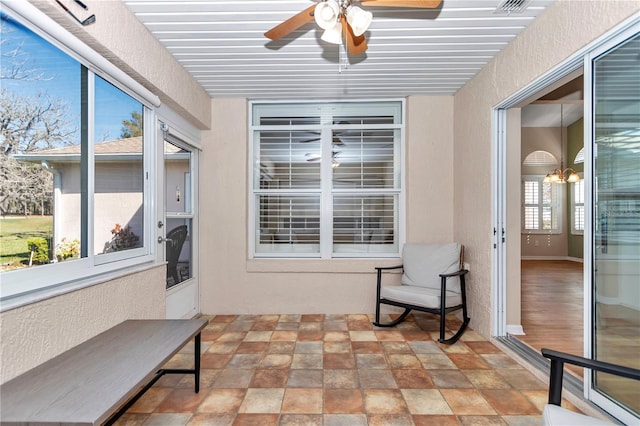 sunroom with a ceiling fan