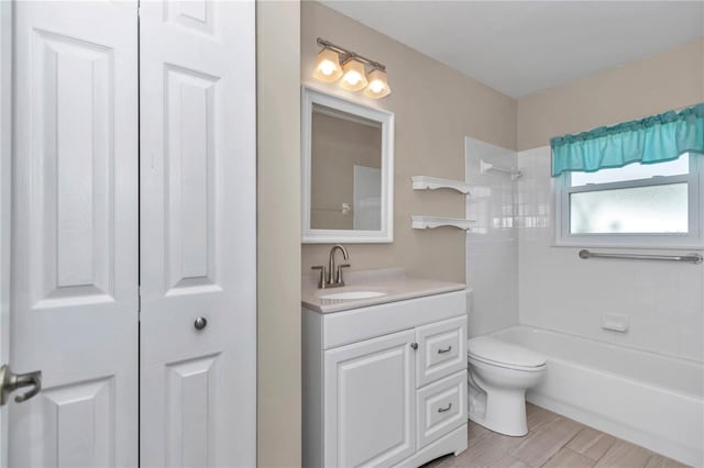 full bathroom featuring toilet, bathtub / shower combination, and vanity