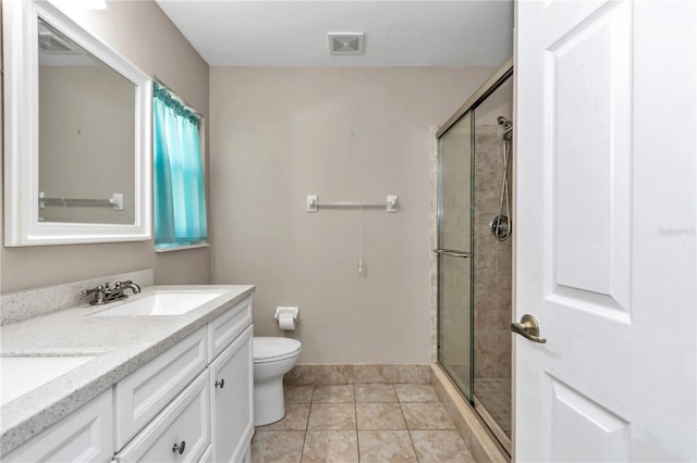 full bath with visible vents, double vanity, a stall shower, a sink, and toilet