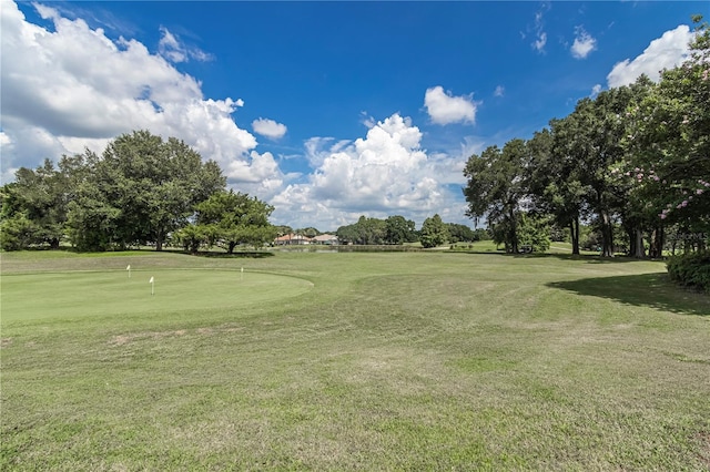 view of home's community with a yard and golf course view