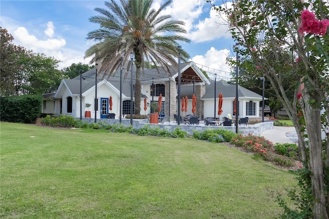 view of front of property featuring stone siding, stucco siding, and a front yard