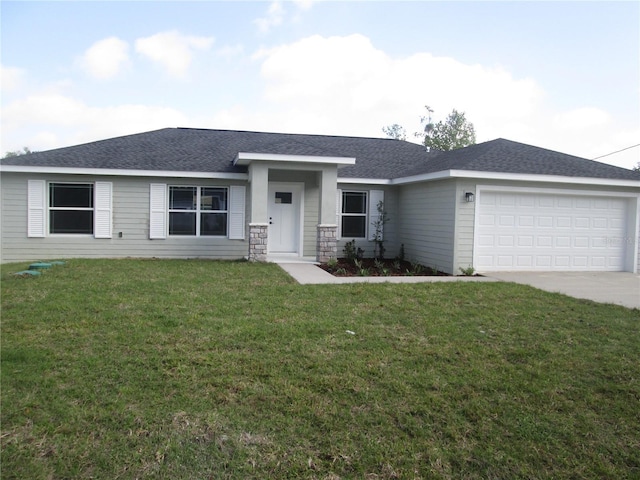 view of front of home with driveway, a shingled roof, a garage, and a front yard