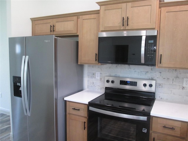 kitchen featuring light countertops, stainless steel appliances, and backsplash