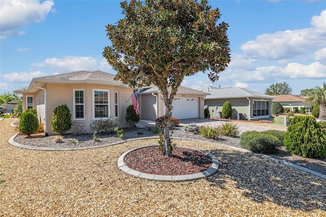 ranch-style house featuring concrete driveway, an attached garage, and stucco siding