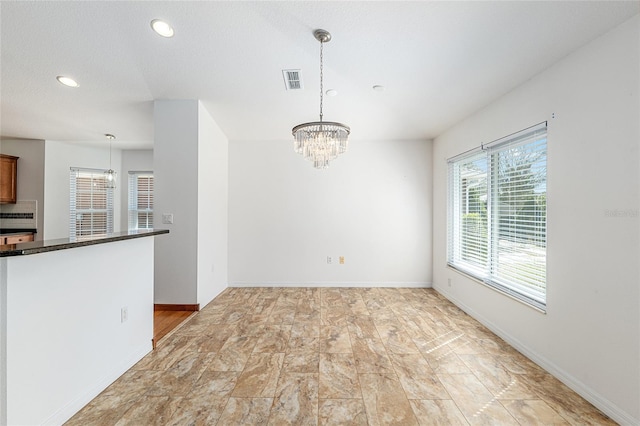 unfurnished dining area featuring recessed lighting, visible vents, baseboards, and an inviting chandelier