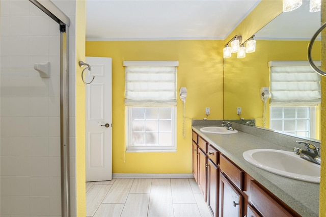 bathroom featuring a sink, plenty of natural light, and a tile shower