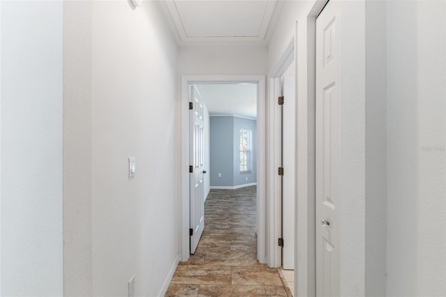 hall with crown molding and baseboards