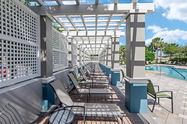 view of patio with a community pool and a pergola