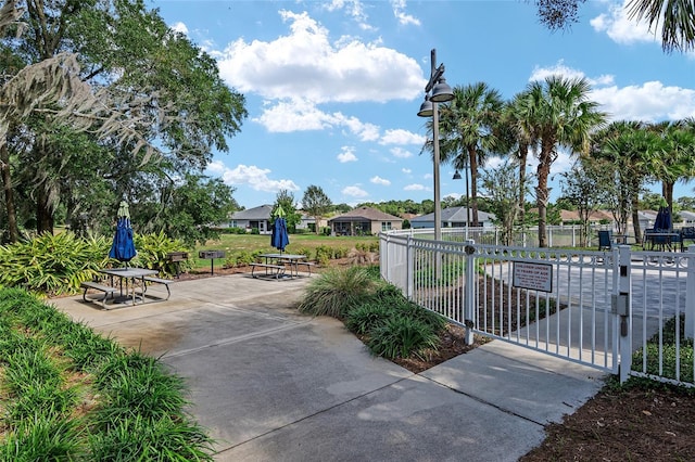 view of community with a gate and fence