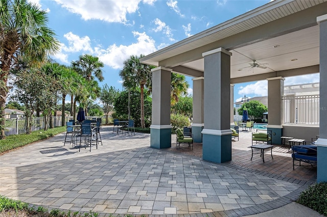 view of patio / terrace with a ceiling fan and fence