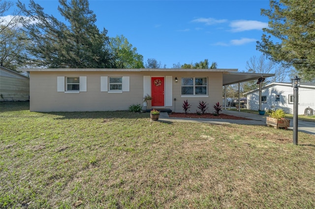 view of front of house with a carport, concrete driveway, and a front lawn