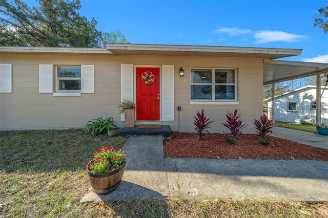 view of front of home with a carport and driveway