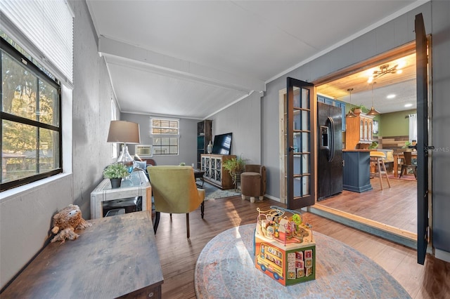 living room with wood finished floors and ornamental molding