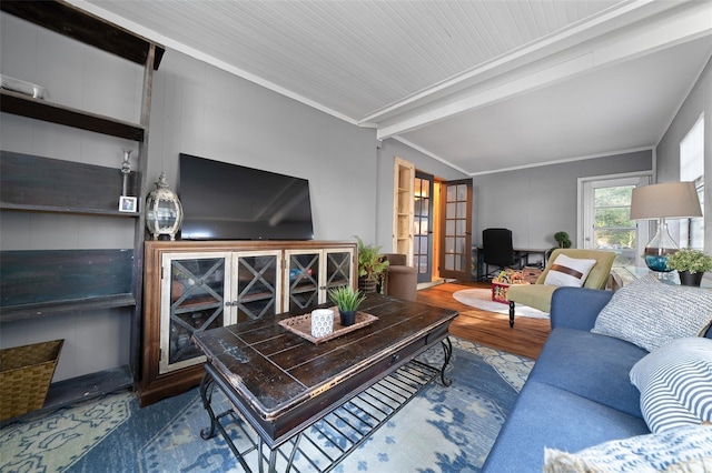 living room featuring beamed ceiling, crown molding, and wood finished floors