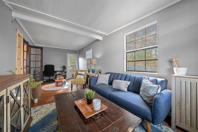 living room featuring beamed ceiling, crown molding, and wood finished floors