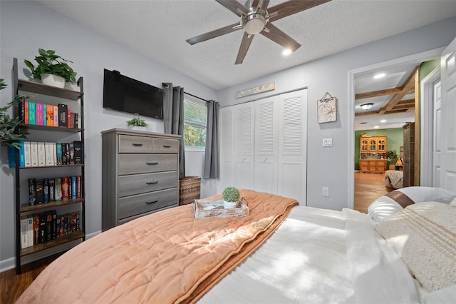 bedroom featuring a closet, recessed lighting, a textured ceiling, and wood finished floors