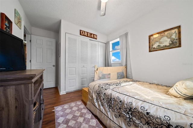 bedroom with dark wood-type flooring, a closet, and a textured ceiling