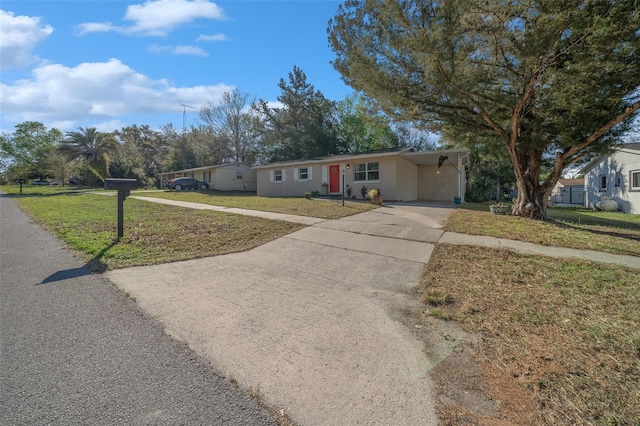 ranch-style home with a front lawn and driveway