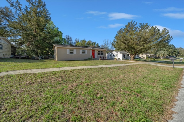 single story home featuring concrete driveway and a front lawn