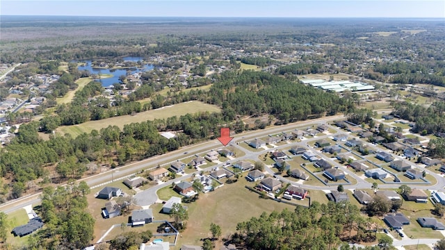 drone / aerial view with a residential view and a water view