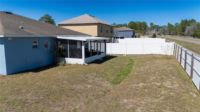 view of yard featuring a fenced backyard and a sunroom