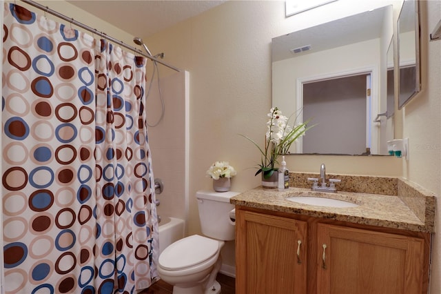 bathroom with vanity, toilet, shower / bath combo, and visible vents