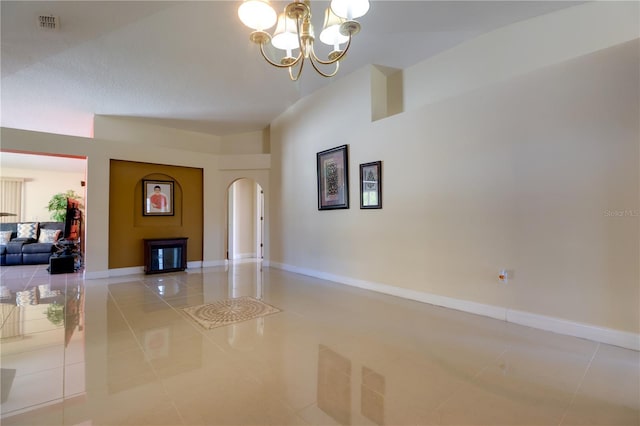 interior space with baseboards, visible vents, an inviting chandelier, light tile patterned flooring, and arched walkways