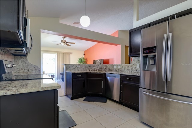 kitchen with a ceiling fan, a peninsula, a sink, decorative backsplash, and stainless steel appliances