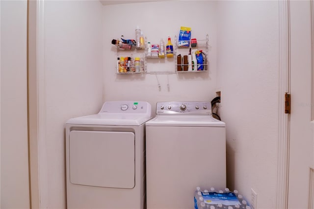 washroom with washer and clothes dryer and laundry area