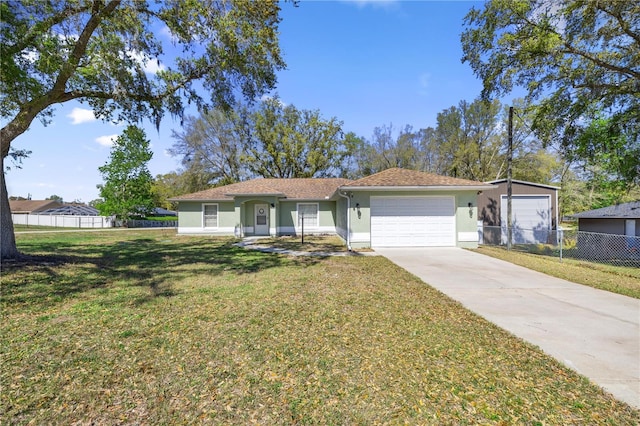 ranch-style home featuring fence, a front yard, stucco siding, a garage, and driveway