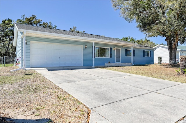 ranch-style home with driveway, an attached garage, and fence