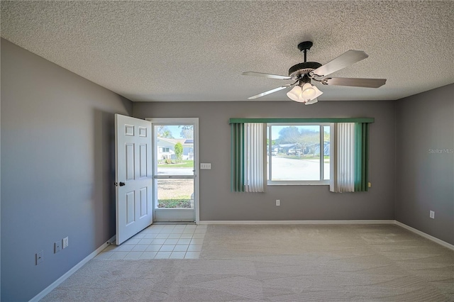 entryway featuring a textured ceiling, a ceiling fan, baseboards, and light carpet