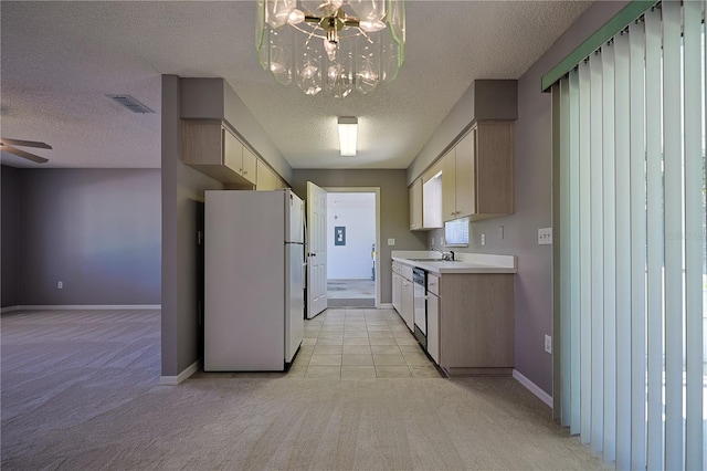 kitchen featuring a sink, light carpet, dishwasher, and freestanding refrigerator