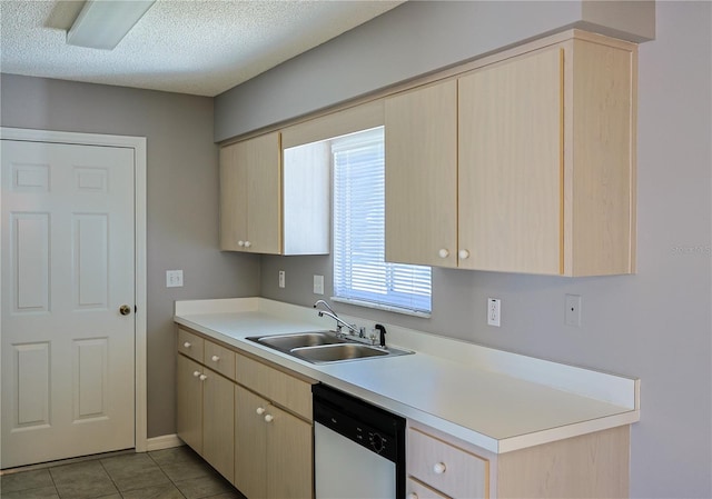 kitchen with light brown cabinets, dishwasher, light countertops, a textured ceiling, and a sink