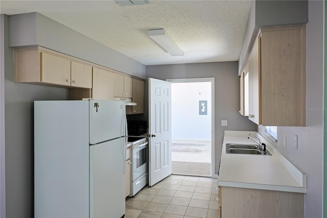 kitchen with light brown cabinets, under cabinet range hood, light countertops, white appliances, and a sink