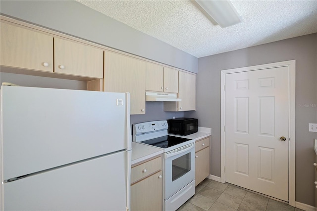 kitchen with under cabinet range hood, light countertops, light tile patterned flooring, white appliances, and a textured ceiling