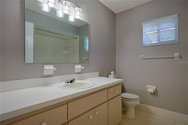 full bath with a shower, toilet, vanity, and baseboards