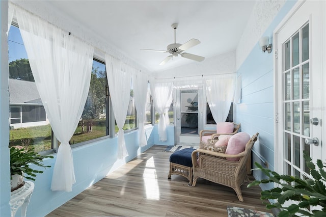 sunroom with lofted ceiling and a ceiling fan