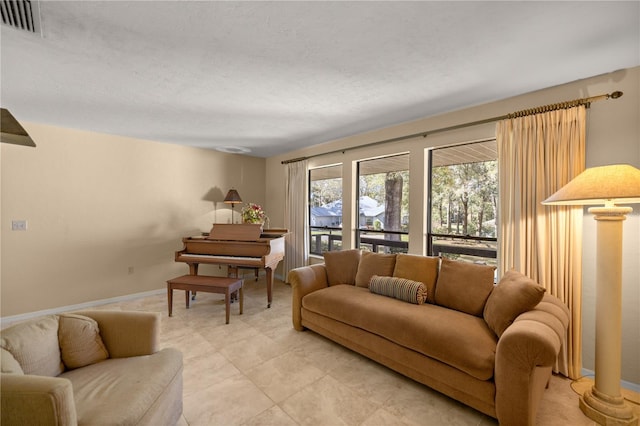 living room featuring baseboards and visible vents