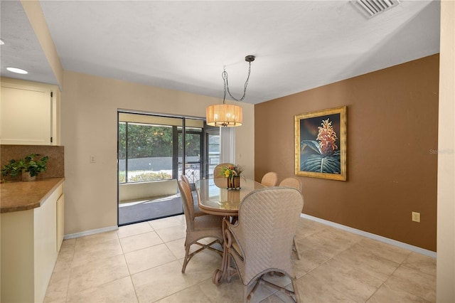 dining room with visible vents, baseboards, a notable chandelier, and light tile patterned flooring