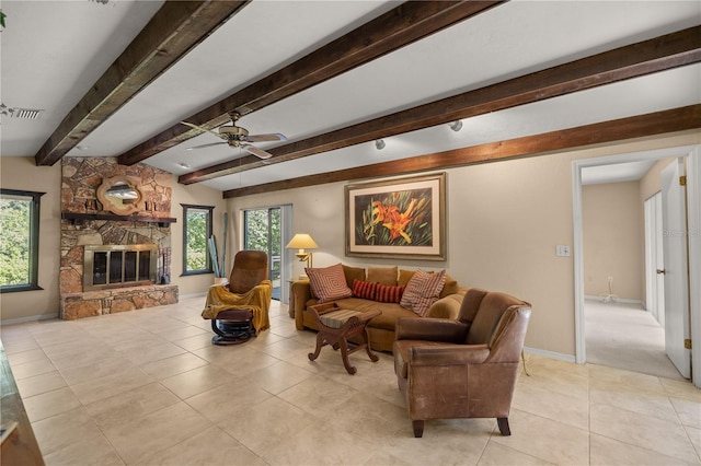 living room featuring tile patterned floors, visible vents, plenty of natural light, and a fireplace