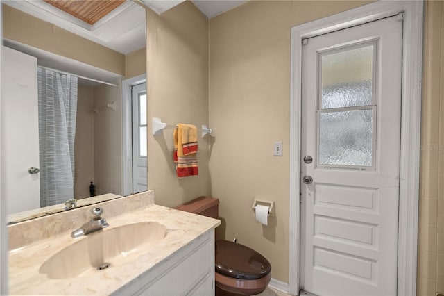 bathroom featuring curtained shower, toilet, and vanity