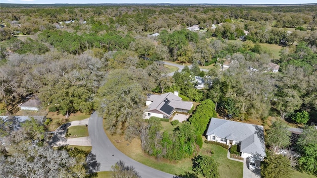 birds eye view of property featuring a view of trees