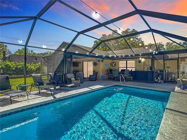 pool with a patio area and a lanai