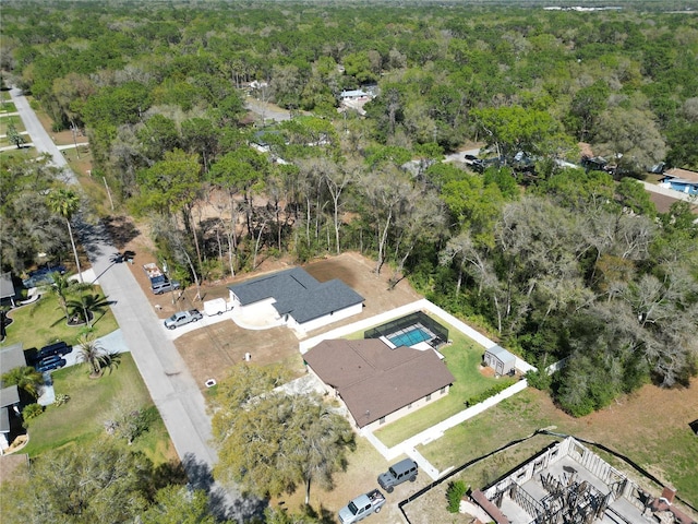 birds eye view of property featuring a view of trees