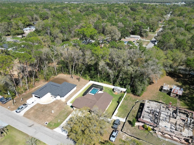 birds eye view of property with a view of trees