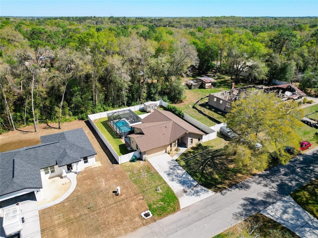 bird's eye view featuring a wooded view